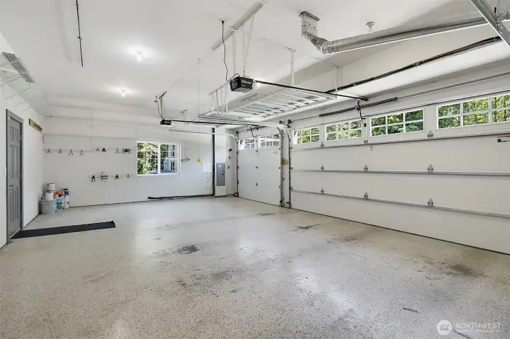 Attached 3-car garage with finished walls, bright lighting, and room for parking, storage, and gear. Attached 3-car garage with finished walls, bright lighting, and room for parking, storage, and gear.