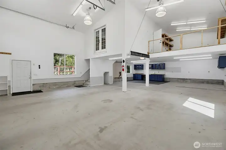 Bright shop interior with open workspace, upper storage, and room for hobbies, equipment, or projects. Bright shop interior with open workspace, upper storage, and room for hobbies, equipment, or projects.