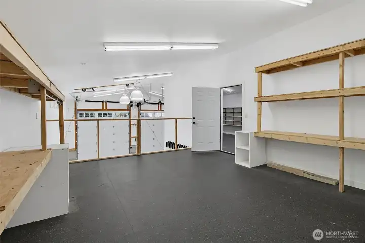 Finished shop workspace with built-in shelving, open floor area, and flexible room for hobbies or storage. Finished shop workspace with built-in shelving, open floor area, and flexible room for hobbies or storage.