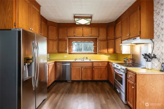 Kitchen has ample storage with cabinets to the ceiling.