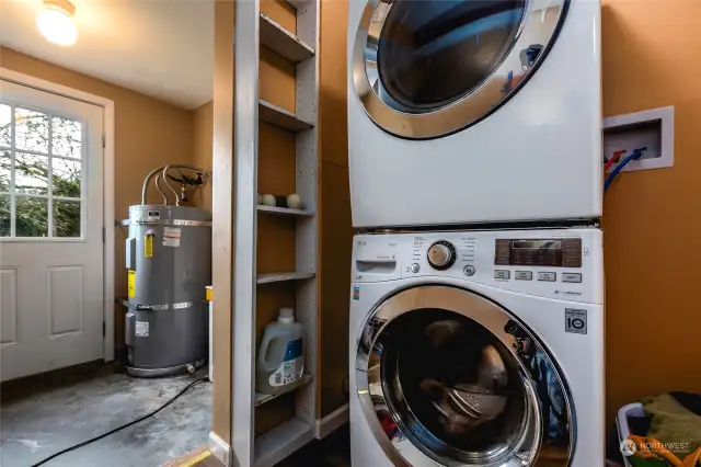 Laundry room has front loading stackable washer/dryer. New water heater installed February 2024. Exit to backyard from laundry/mud room.