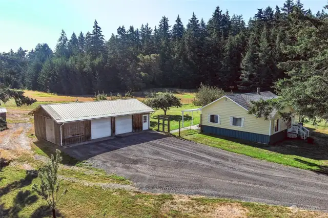 Large 3 car garage. Two roll up door entry points from the front and one from back of garage. Man door leads to a small insulated shop.