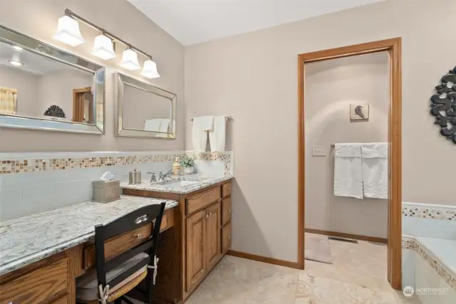 Primary bath with water closet and separate make-up vanity.