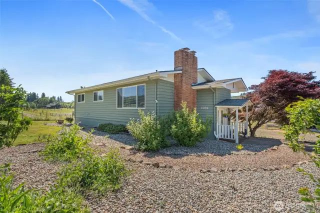 The farmhouse has been thoughtfully updated with numerous upgrades. New vinyl windows provide energy efficiency and timeless appeal, while easy-care flooring offers a perfect blend of style and practicality. The beautifully refreshed low maintenance landscaping creates a warm and inviting atmosphere, making this home a true retreat at the heart of the property