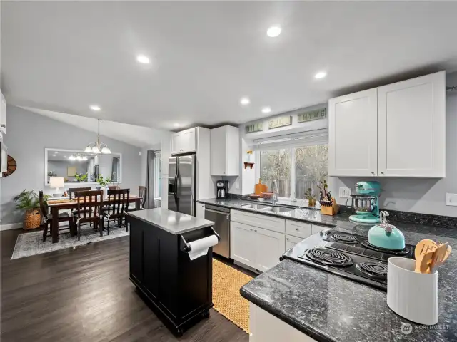 Fully remodeled kitchen overlooking the dining room & backyard