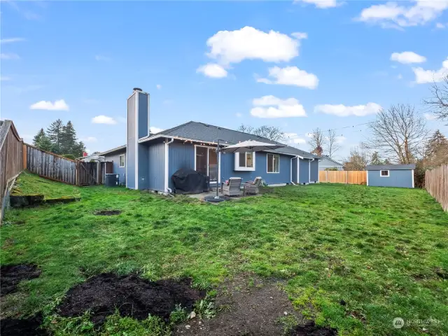 GREAT fully fenced backyard! New seed has been planted on these dirt piles. Someone, who we will not name, had a digging problem ;-)