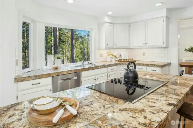 Gleaming, honed granite countertops with a subway tile backsplach highlight this chef's kitchen!