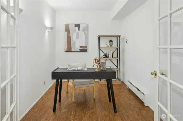 Den on the lower level w/french doors and engineered hardwood flooring.