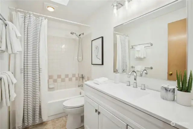 A full bathroom on the upper level has been recently updated with a new vanity + new flooring and toilet.