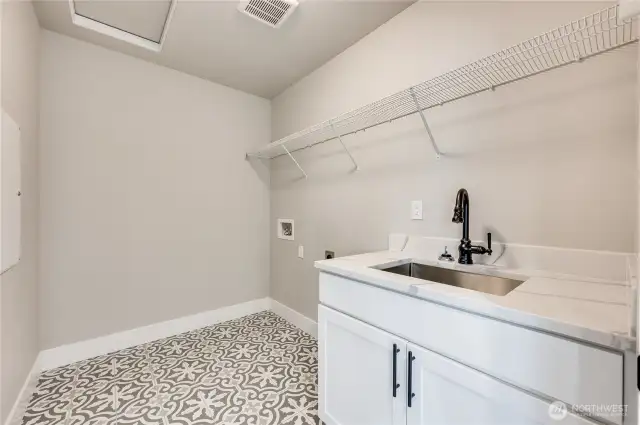 This photo of another floorplan to show example of finishes in laundry room. Details will vary.