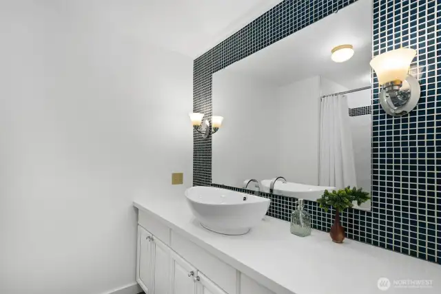 Designed with detail. Tub/shower combo, sleek bowl sink, and custom tile work—this upstairs bathroom has it all.