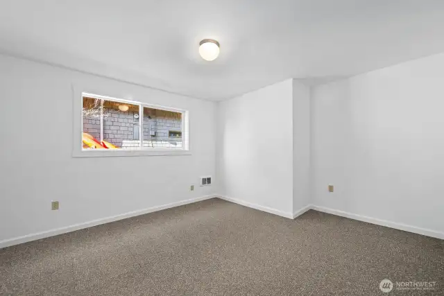 A blank canvas for your style. Freshly painted downstairs bedroom—perfect for a peaceful retreat.