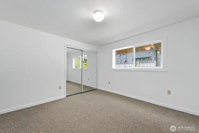 A blank canvas for your style. Freshly painted downstairs bedroom—perfect for a peaceful retreat.