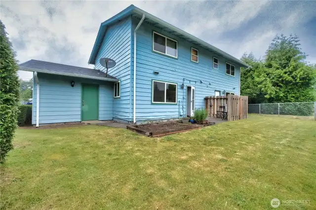 Backyard fenced complete with garden bed