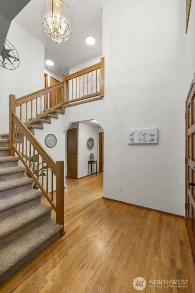 Large foyer with oak hardwood floors.