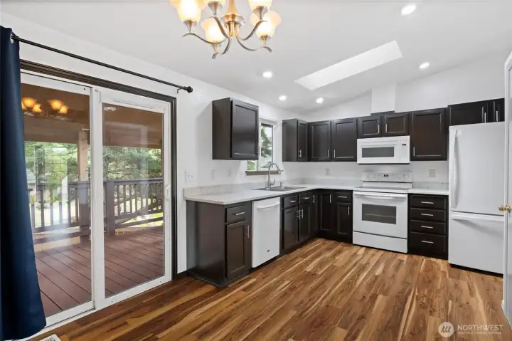 Kitchen with eating area opens to wrap-around deck.