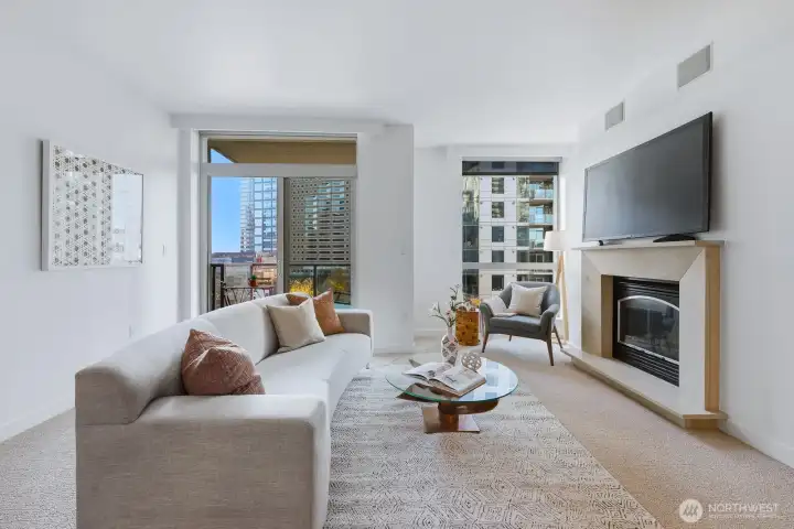 Inviting Living Room: Features a gas fireplace and western-facing windows, offering plenty of natural light and views of downtown Bellevue.