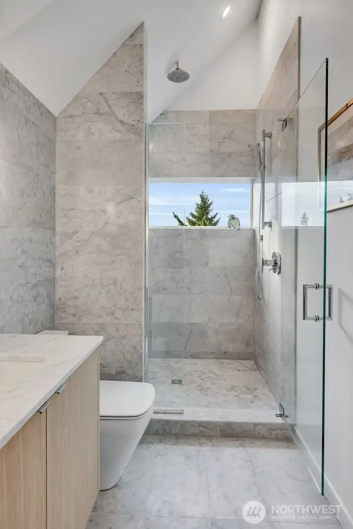 Full Carrara marble throughout bathroom.