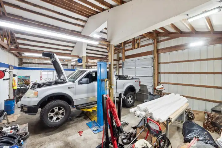 A true standout feature, this oversized shop is built for serious projects. High ceilings, wide bay doors, and durable concrete floors create an ideal workspace for vehicles, tools, or equipment. The professional-grade car lift is included, offering an incredible setup for mechanics, hobbyists, or anyone needing substantial shop space.