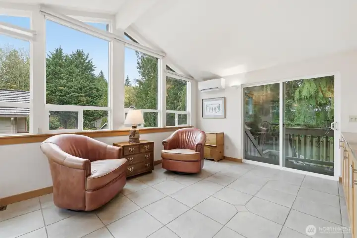 The gathering space adjacent to the kitchen is ready for you to furnish as you wish.  Through the sliding glass door you will find a covered deck which provides access to the yard and the perfect spot for your bbq!