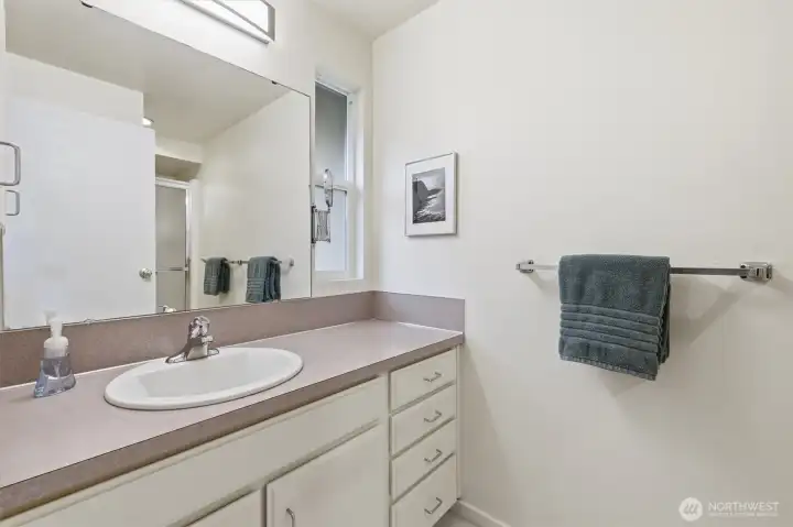 The 3/4 bathroom in the primary suite.
