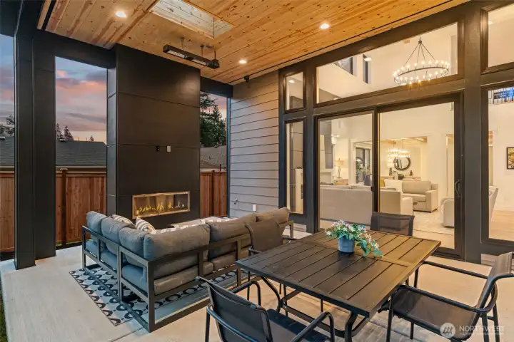 Large patio with sitting and eating area, with heaters