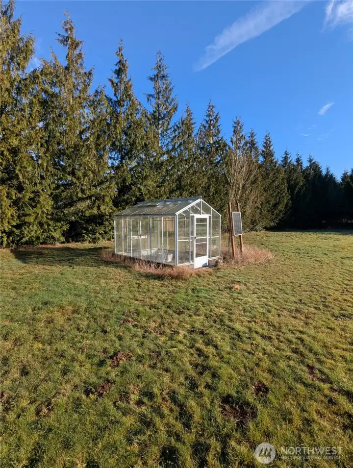 Greenhouse on cement pad.