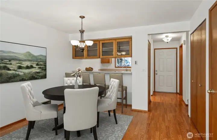 Dining area. Also includes a high counter bar. With convenient custom display area for special pieces. Digitally staged.