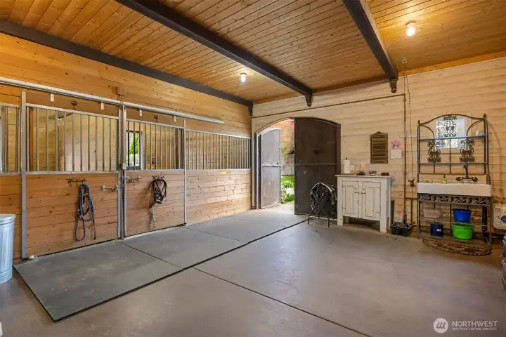 Interior of the barn. 720sf. Finished walls with 10 ft wood ceilings. Water, power, cable & water heater. Freeze protected water troughs.