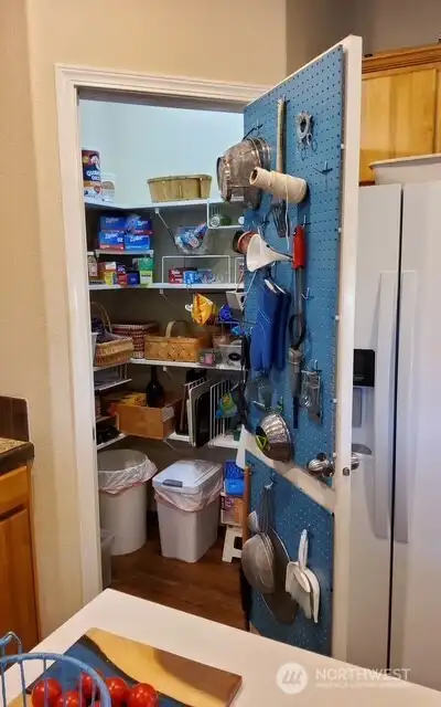 Generous pantry space complete with a built-in peg board designed for tidy, accessible utensil storage.