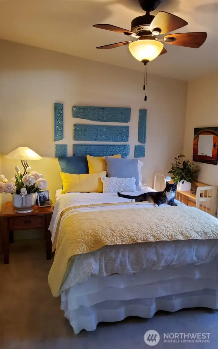 An attractive guest bedroom designed for comfort and privacy, with a convenient opening to the living room that allows it to function equally well as a den.