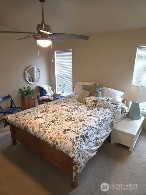 Primary bedroom includes a ceiling fan and an adjoining bathroom, creating a private and functional retreat. Primary bedroom includes a ceiling fan and an adjoining bathroom, creating a private and functional retreat.