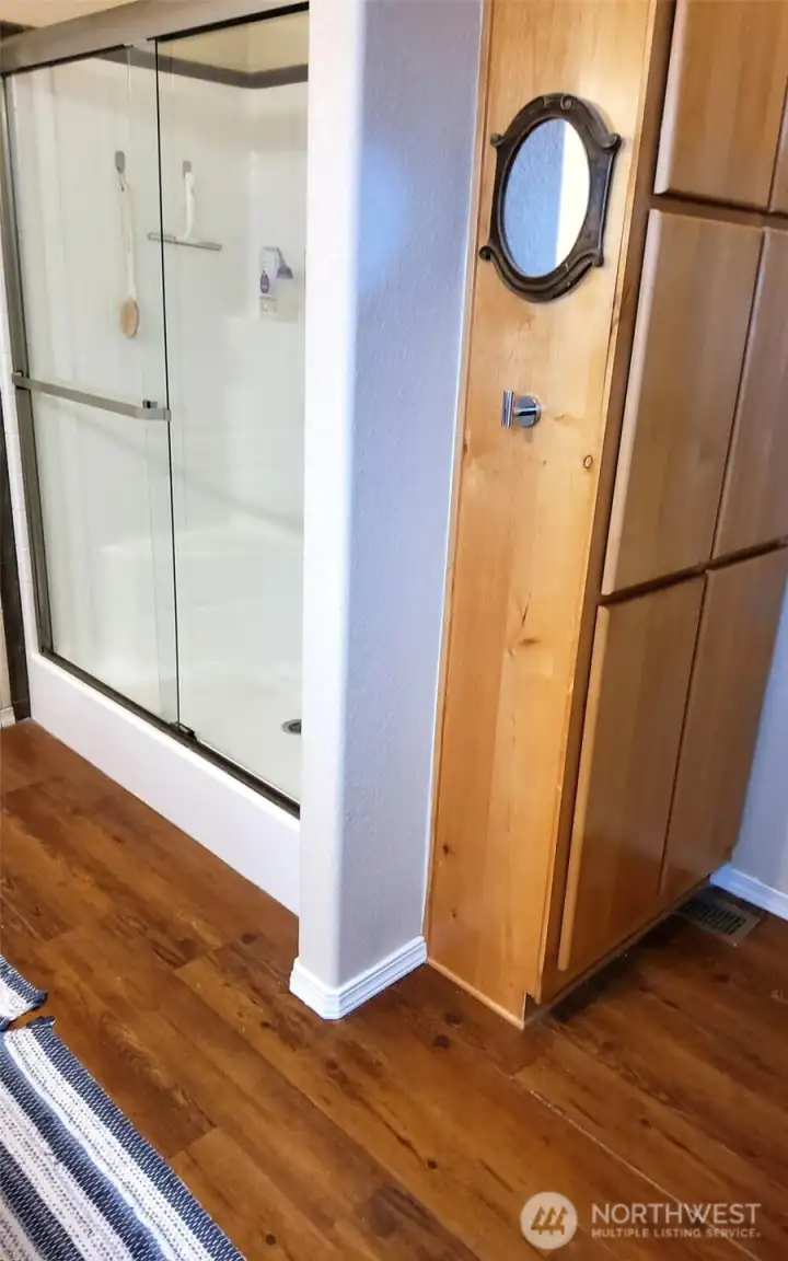 Walk-in shower and convenient storage are additional features of primary bath.