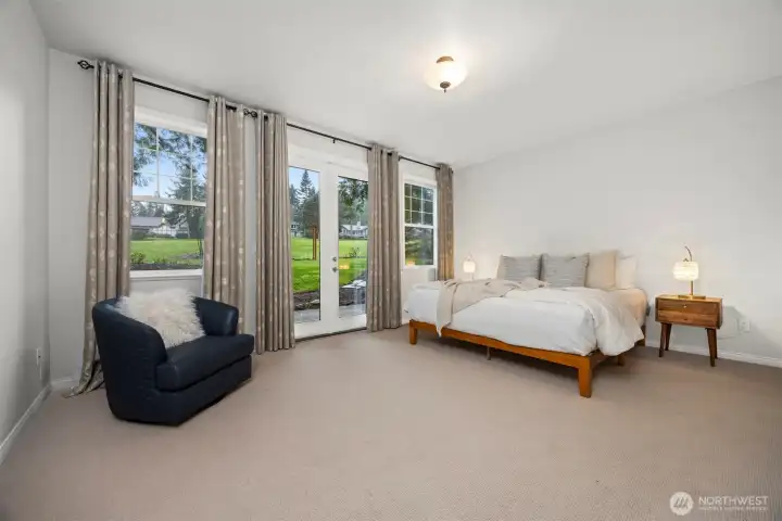 The primary suite is a true retreat, with French doors opening directly to the deck.