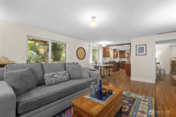 The doorway at the far right leads to the living room and entry. The large slider opens to a covered patio perfect for PNW outdoor living.