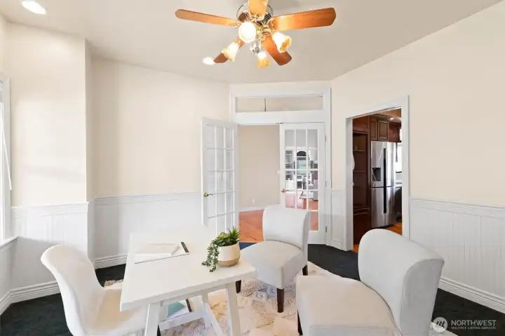 A light filled office with kitchen and entryway access.