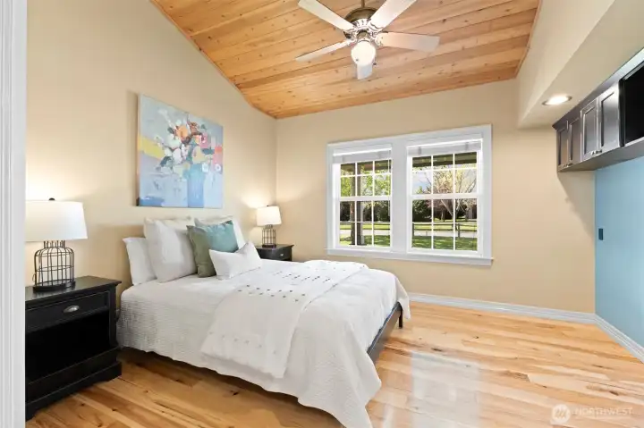 Bedroom #2 with pine planked vaulted ceilings and built in cabinet storage. Walk in closet with automatic lighting (off camera to left), real hardwood floors and high quality Casablanca ceiling fan. Wired with coax.