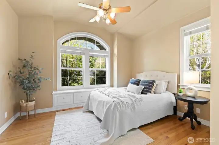 Bedroom #3 with built in window seat and storage, vaulted ceilings, walk in closet with automatic lighting (off camera to the right), and real hardwood floors. High quality Casablanca ceiling fan. Wired with coax.