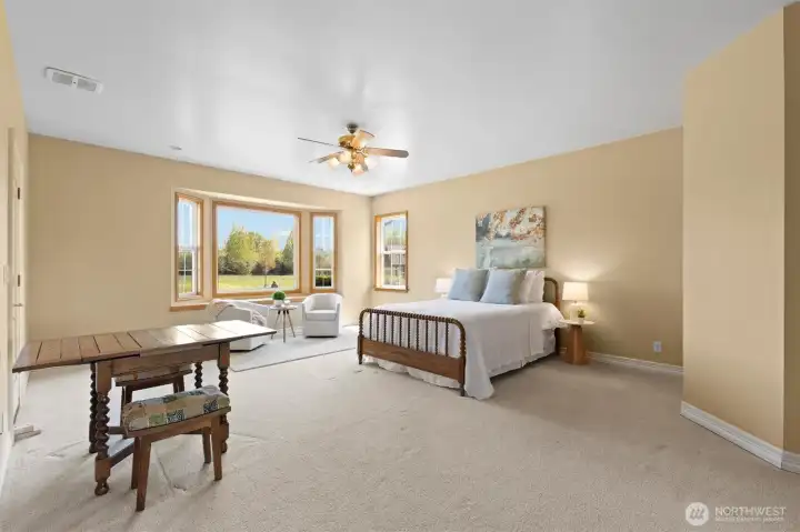 Guest en suite or second primary bedroom on the main floor.  Gorgeous backyard and mountain views.  Access to back patio and three quarter bath. High quality Casablanca ceiling fan.