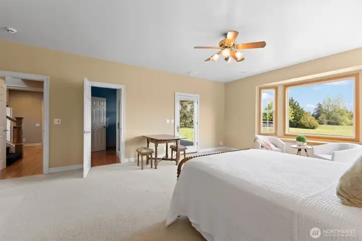 Guest en suite or second primary on the main floor, looking towards three quarter bath at center and hallway access on the left.  Closet is also off camera on the left.