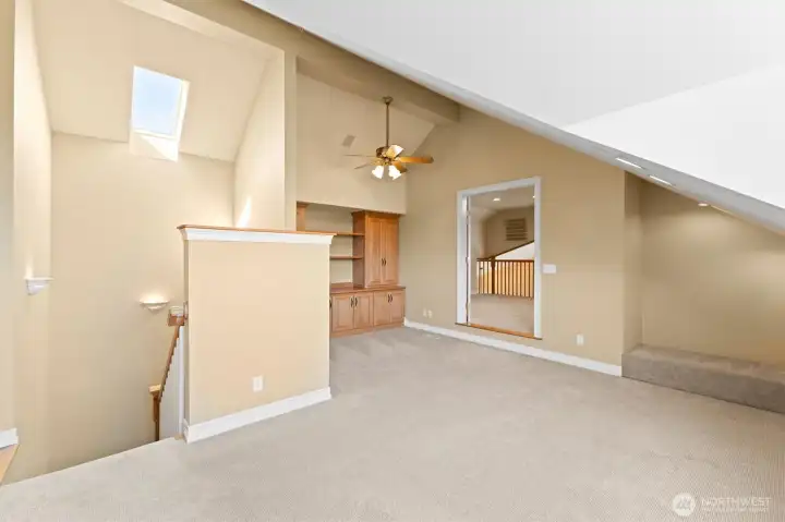 Another view of the upstairs flex space/den with built in storage. High quality Casablanca ceiling fan. Notice the reading nook on the far right.  Double doors at center lead to loft.