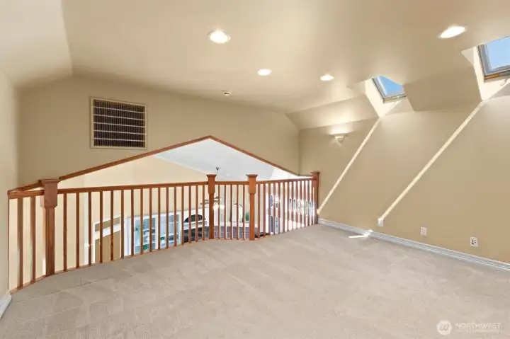 Loft, looking down into living room.  Could be used as an office, exercise space, playroom.  Wired for internet.