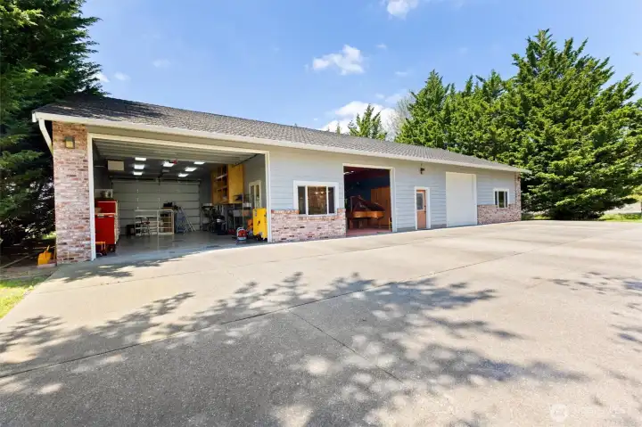 This 3,200 sq ft outbuilding contains an ADU and garage (far right), gameroom with garage door (center), and shop. The shop has 10.5' garage doors at both ends, is heated, insulated, has hot/cold water, a wash sink, 50 amp outlets, built in storage and is hardwired for internet. Excellent lighting.