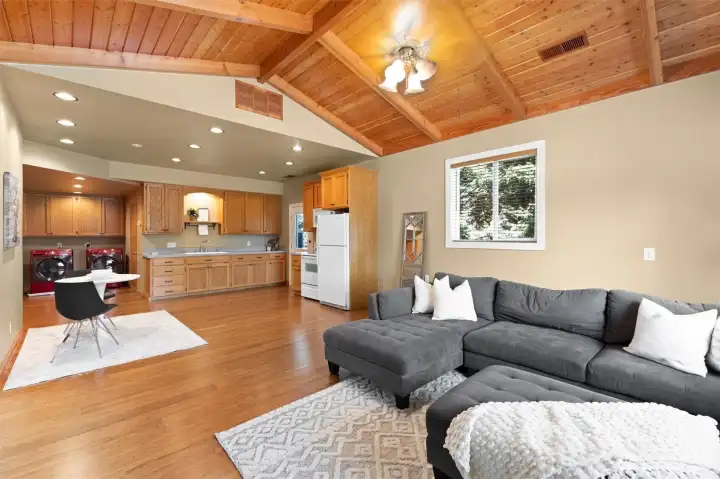 Detached ADU.  Heated and air conditioned. Notice the beautiful vaulted cedar plank ceiling with high quality Casablanca ceiling fan.  Washer/dryer hookups.  Three quarter bath behind the kitchen, and bedroom to the left of washer/dryer.