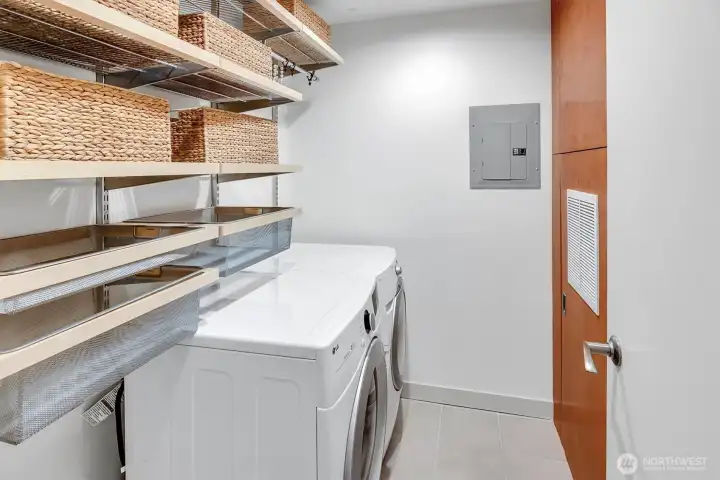 Large laundry room with Elfa shelving and full-sized W/D