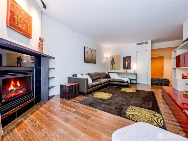 The ultimate cozy vibe featuring a signature gas fireplace, central AC, and automated electric blackout blinds.