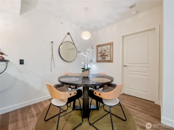 Sun-drenched, sophisticated dining space framed by warm wood tones and clean designer lines.