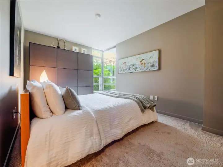 Fall asleep in a high-design bedroom retreat looking directly onto a peaceful, quiet courtyard garden.