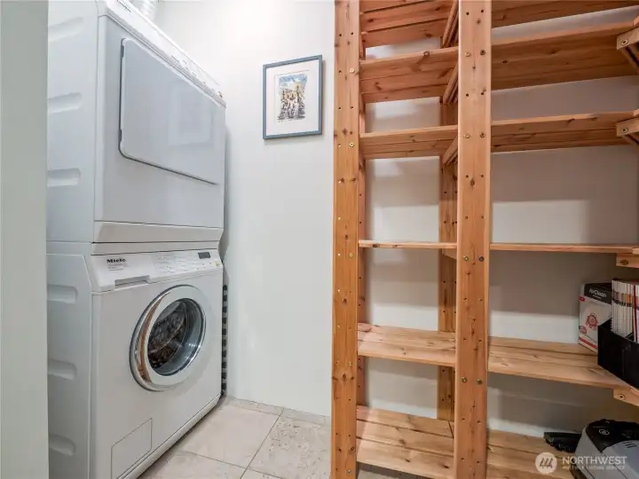 Complete convenience tucked away neatly with an upgraded, top-tier stacked Miele washer and dryer system, and a spacious pantry.