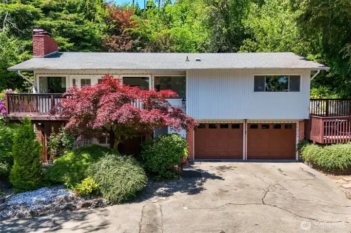 Nestled among mature landscaping and lush greenery, this inviting split-level home offers a peaceful setting with beautifully layered grounds and timeless curb appeal. Thoughtfully designed terraces and natural surroundings create a private retreat full of warmth and character. Nestled among mature landscaping and lush greenery, this inviting split-level home offers a peaceful setting with beautifully layered grounds and timeless curb appeal. Thoughtfully designed terraces and natural surroundings create a private retreat full of warmth and character.